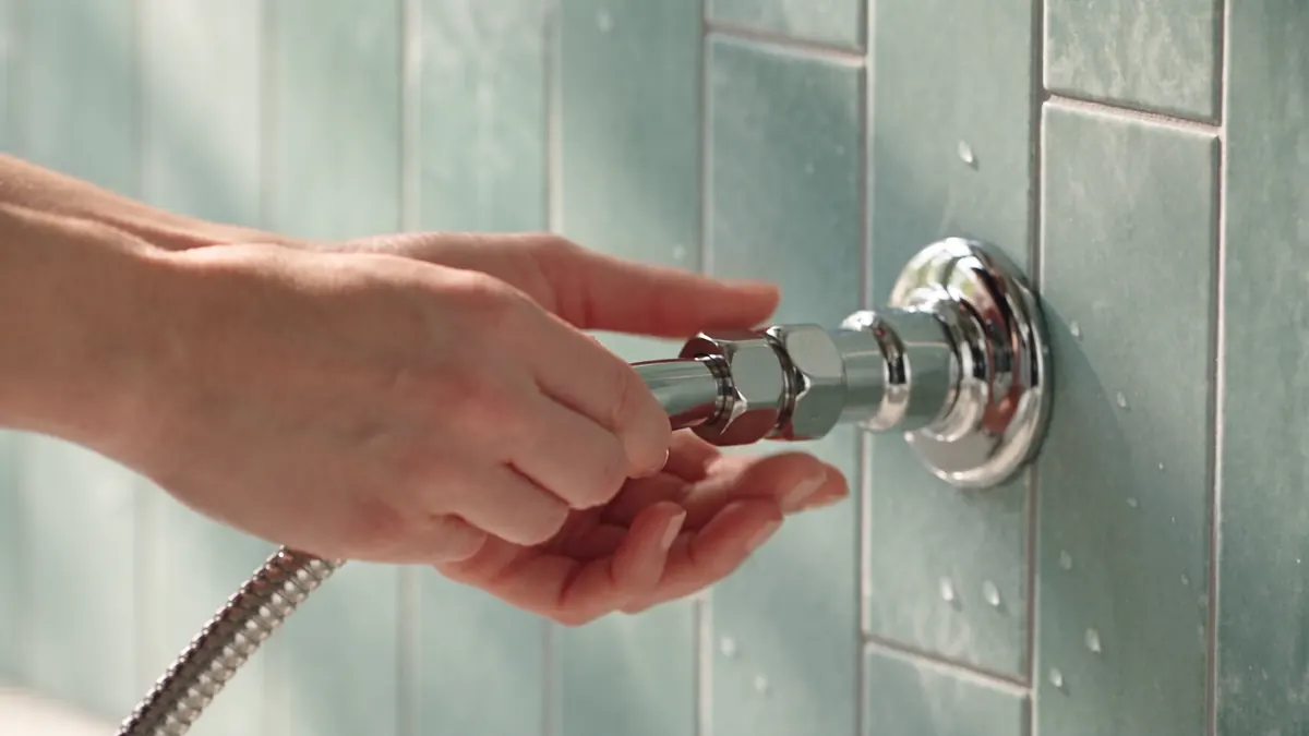 Hands connecting the ANESPA DX hose to a shower outlet